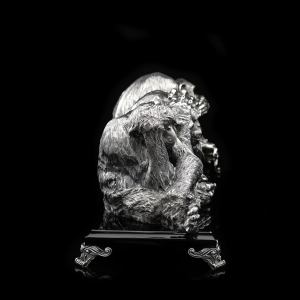 Silver sculpture "Three monkeys" on obsidian