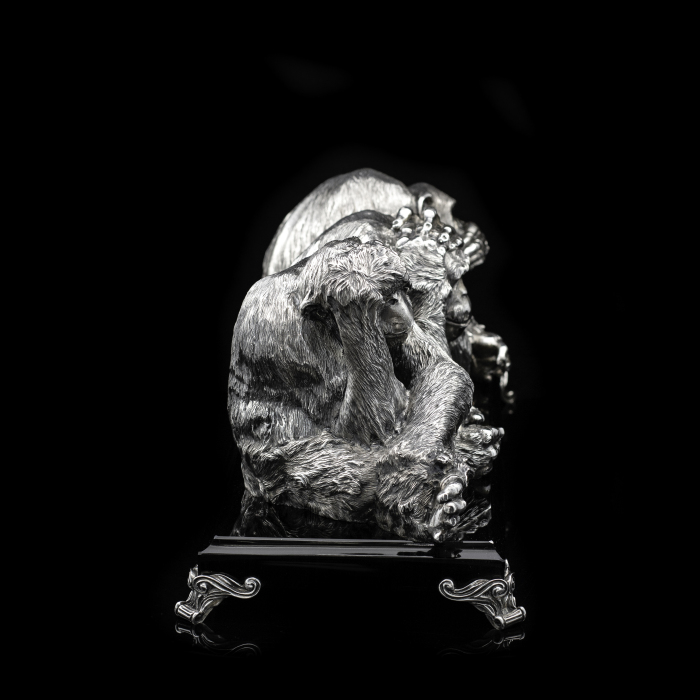 Silver sculpture "Three monkeys" on obsidian