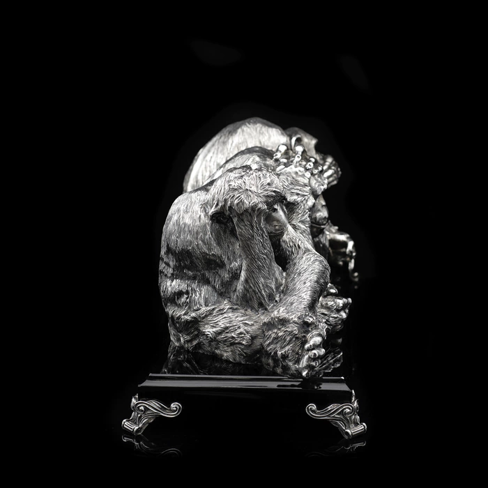 Silver sculpture "Three monkeys" on obsidian