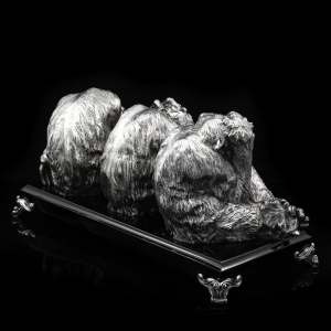 Silver sculpture "Three monkeys" on obsidian