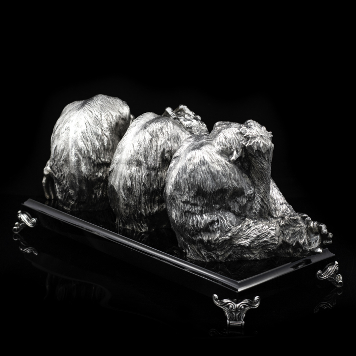 Silver sculpture "Three monkeys" on obsidian