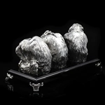 Silver sculpture "Three monkeys" on obsidian