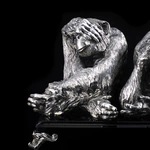 Silver sculpture "Three monkeys" on obsidian