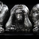 Silver sculpture "Three monkeys" on obsidian