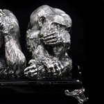 Silver sculpture "Three monkeys" on obsidian
