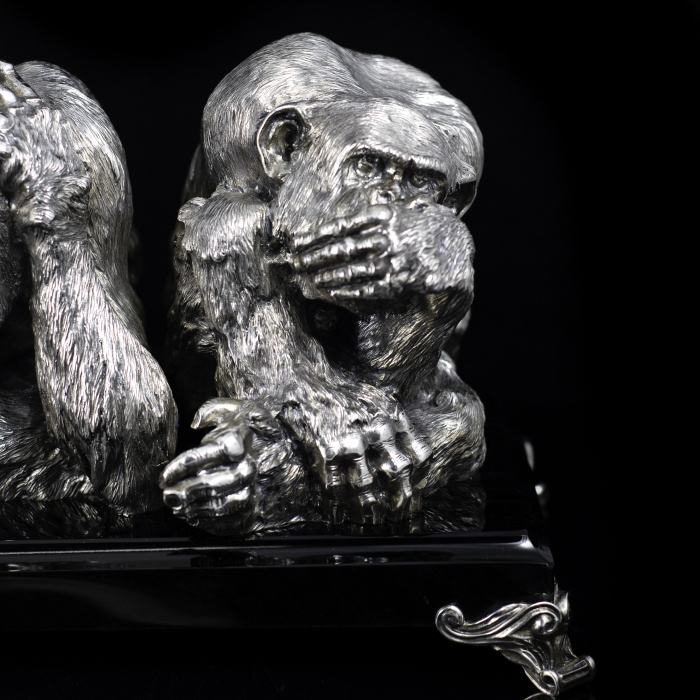 Silver sculpture "Three monkeys" on obsidian