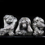 Silver sculpture "Three monkeys" on obsidian