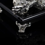 Silver sculpture "Three monkeys" on obsidian