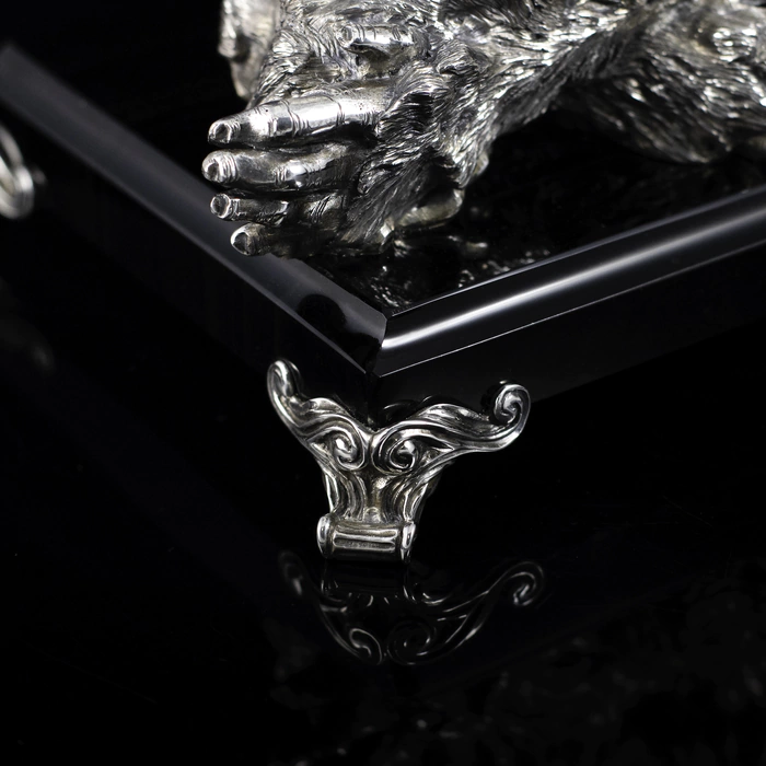 Silver sculpture "Three monkeys" on obsidian