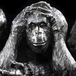Silver sculpture "Three monkeys" on obsidian
