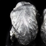 Silver sculpture "Three monkeys" on obsidian