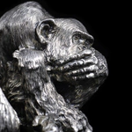 Silver sculpture "Three monkeys" on obsidian