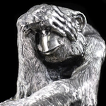 Silver sculpture "Three monkeys" on obsidian