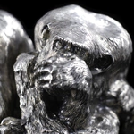 Silver sculpture "Three monkeys" on obsidian