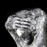 Silver sculpture "Three monkeys" on obsidian