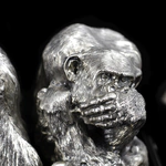 Silver sculpture "Three monkeys" on obsidian