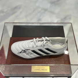 Autographed sneakers of football player Lionel Messi, wood