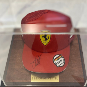 Autographed cap of racing driver Sebastian Vettel, wood