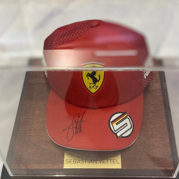 Autographed cap of racing driver Sebastian Vettel, wood