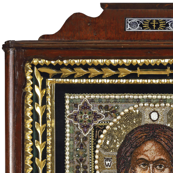 The embroidered icon "The Lord Almighty" in an antique frame and a kiosk