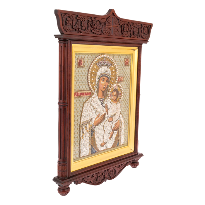 The embroidered icon of the Mother of God in an antique kiosk