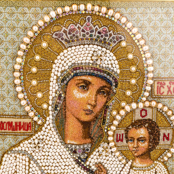 The embroidered icon of the Mother of God in an antique kiosk