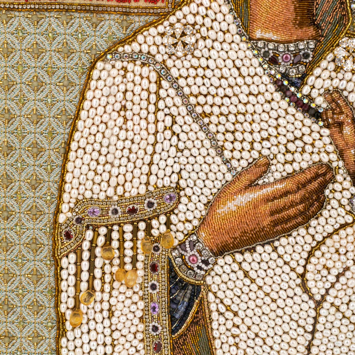 The embroidered icon of the Mother of God in an antique kiosk