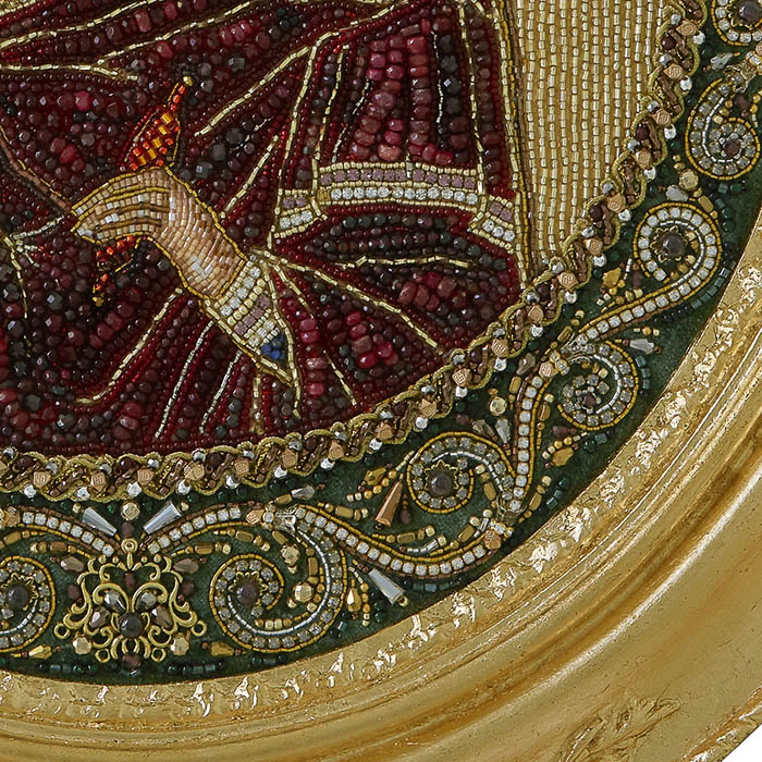 The embroidered icon of the Annunciation. The Virgin" in a frame