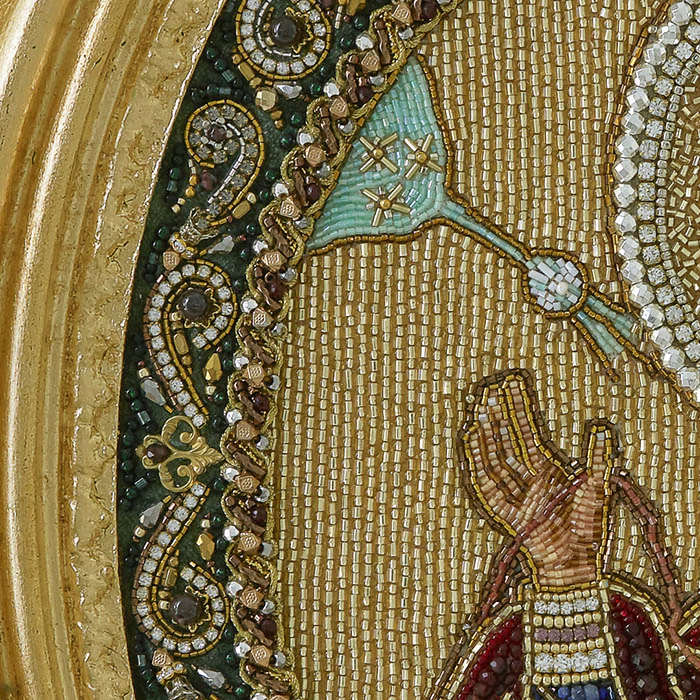 The embroidered icon of the Annunciation. The Virgin" in a frame