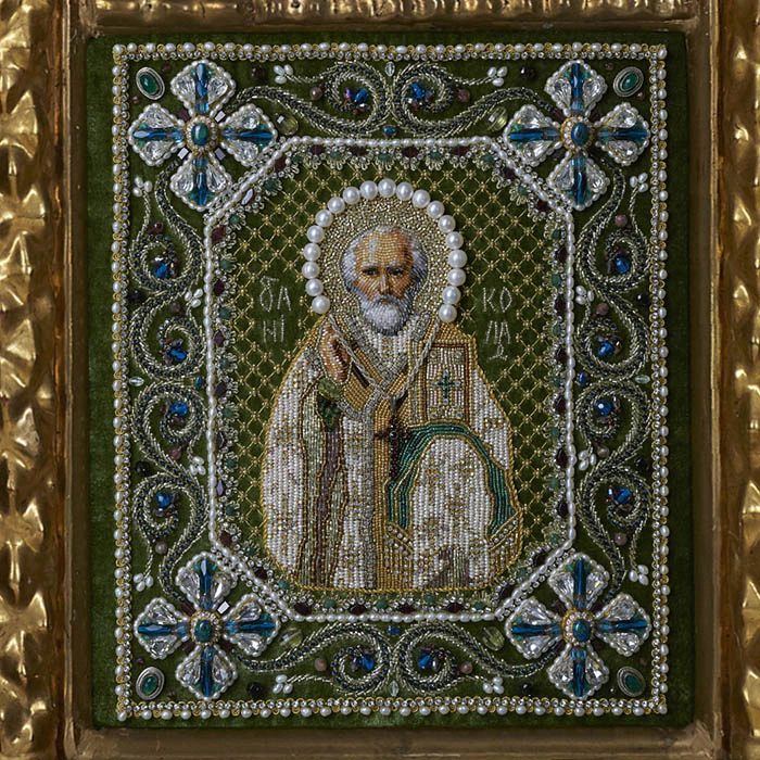 The embroidered triptych icon "The Lord Almighty. Our Lady of Vladimir. St. Nicholas the Wonderworker"" in an antique frame and a kiosk