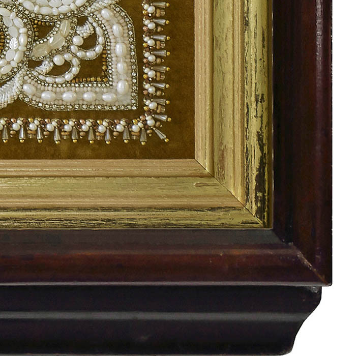 The embroidered icon "Our Lady of Feodorovskaya" in a frame and a kiosk