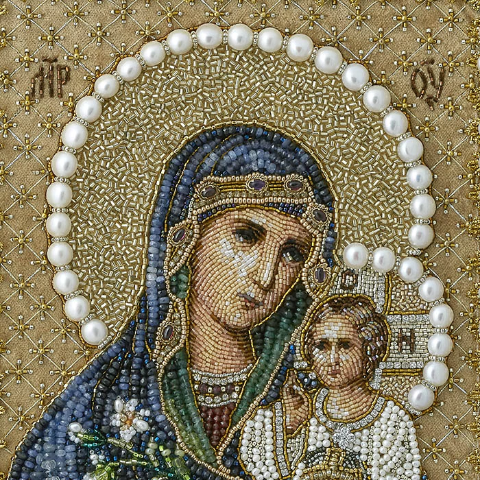 The embroidered icon "Our Lady of Unfading Color" in a frame and antique case