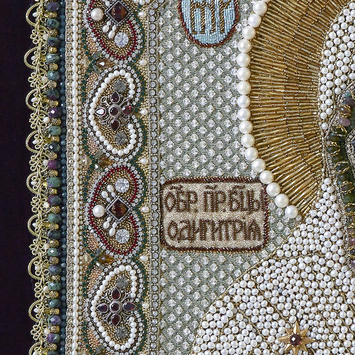 The embroidered icon of Our Lady of Odigitria in a frame and antique case