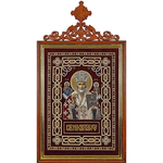 Embroidered icon of St. Nicholas the Wonderworker in a frame and a kiosk