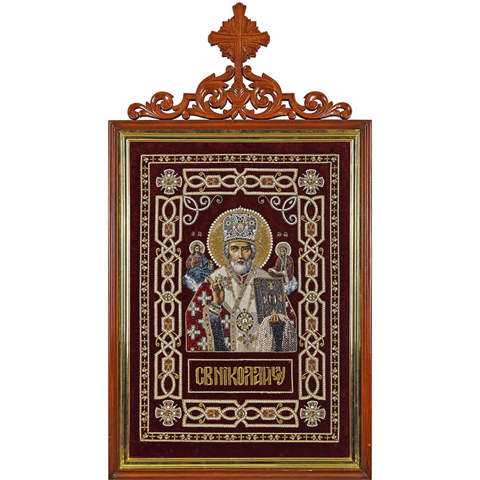 Embroidered icon of St. Nicholas the Wonderworker in a frame and a kiosk