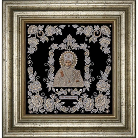 The embroidered icon of St. Nicholas the Wonderworker in a frame