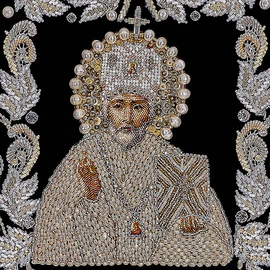 The embroidered icon of St. Nicholas the Wonderworker in a frame