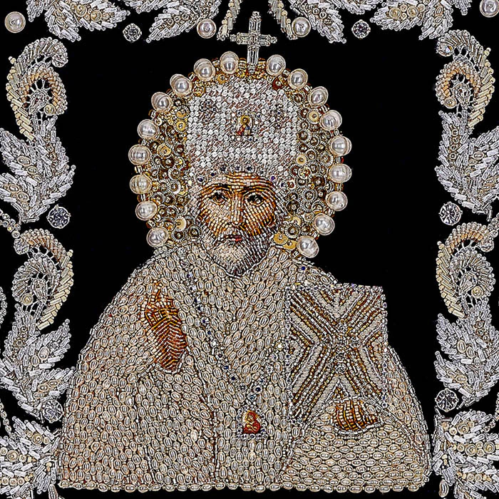 The embroidered icon of St. Nicholas the Wonderworker in a frame