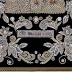 The embroidered icon of St. Nicholas the Wonderworker in a frame
