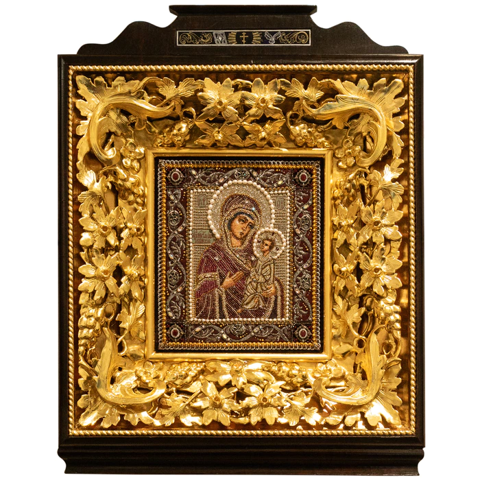 The embroidered icon "The Most Holy Theotokos of Tikhvin" in an antique kiosk