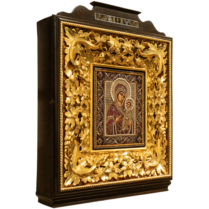 The embroidered icon "The Most Holy Theotokos of Tikhvin" in an antique kiosk