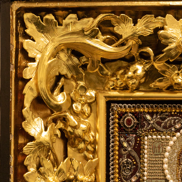 The embroidered icon "The Most Holy Theotokos of Tikhvin" in an antique kiosk