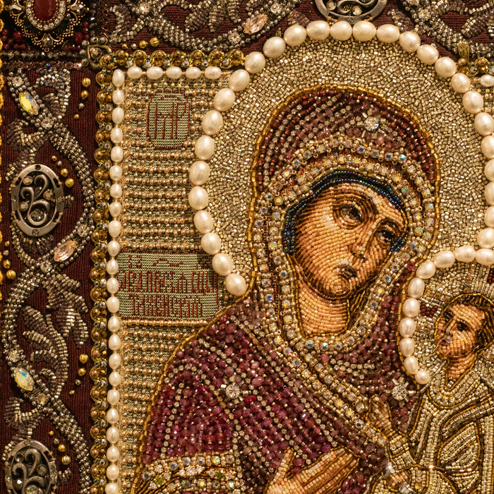 The embroidered icon "The Most Holy Theotokos of Tikhvin" in an antique kiosk