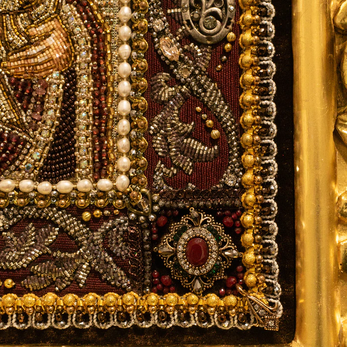The embroidered icon "The Most Holy Theotokos of Tikhvin" in an antique kiosk
