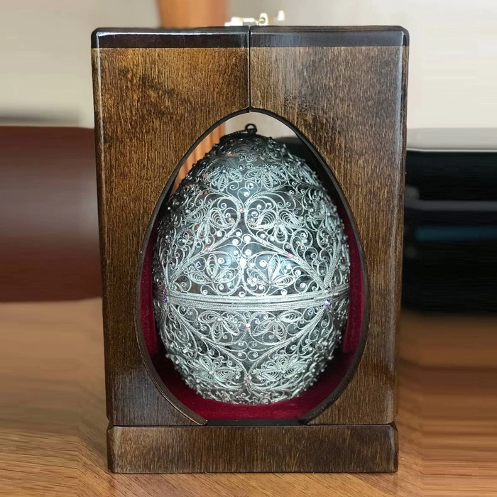 Honeydew egg in a filigree case