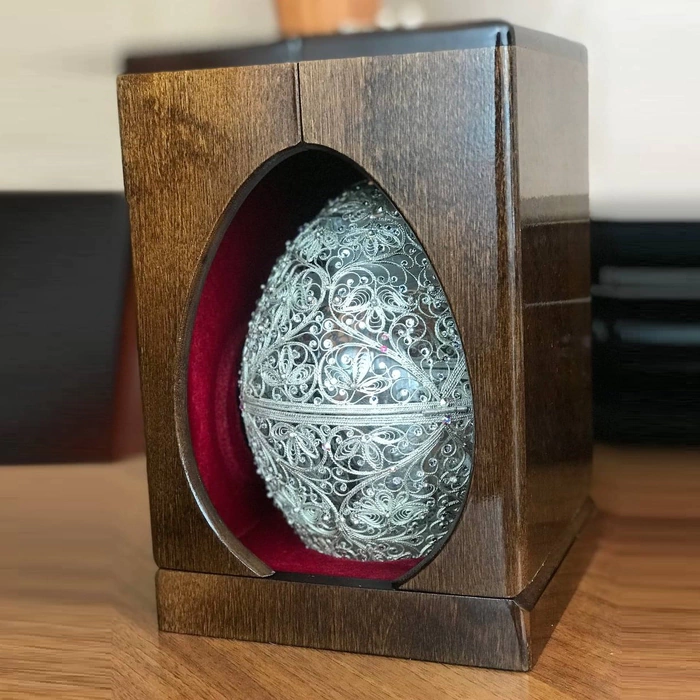 Honeydew egg in a filigree case