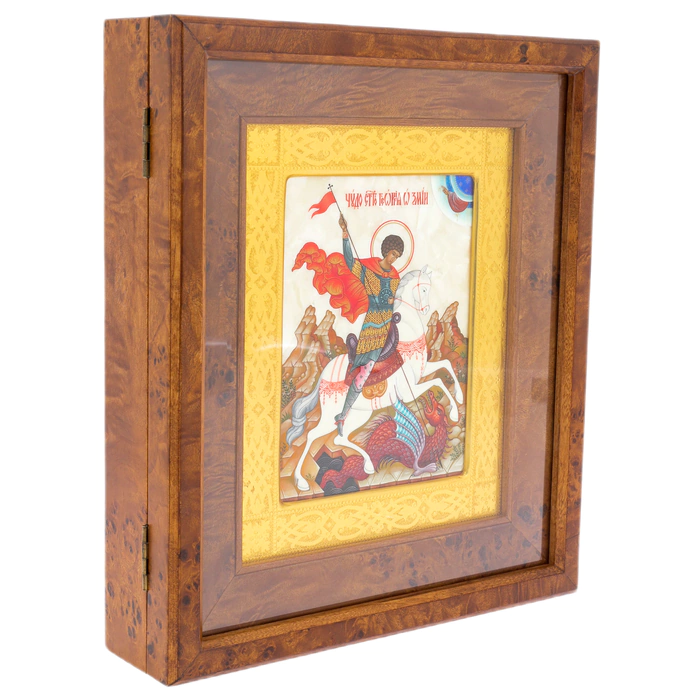The icon of St. George the Victorious in a kiosk and a gold frame on natural mother-of-pearl