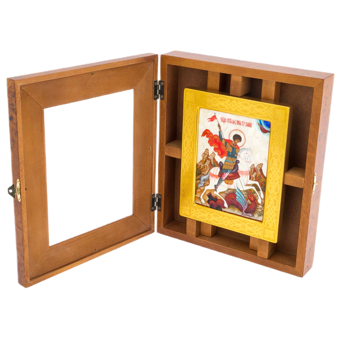 The icon of St. George the Victorious in a kiosk and a gold frame on natural mother-of-pearl