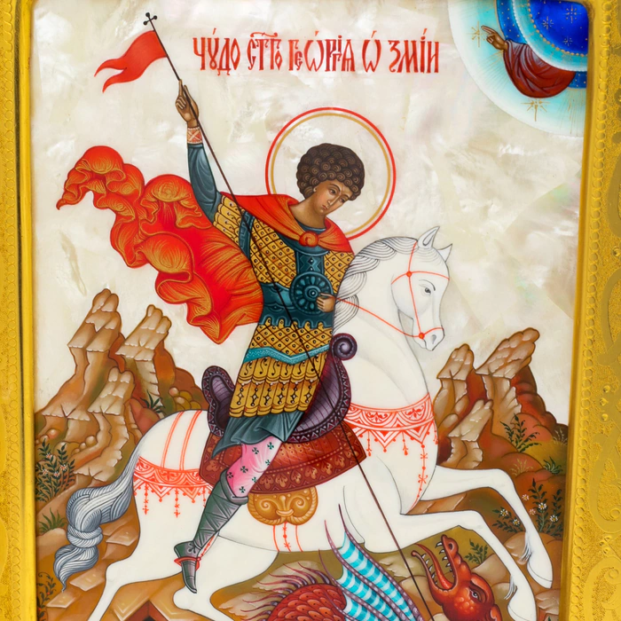 The icon of St. George the Victorious in a kiosk and a gold frame on natural mother-of-pearl