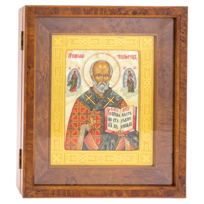 The icon of St. Nicholas the Wonderworker in a kiosk and a gold frame on natural mother-of-pearl
